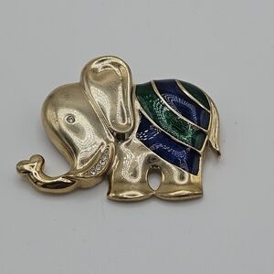 gold tone elephant pin with rhinestones and blue and green enamel